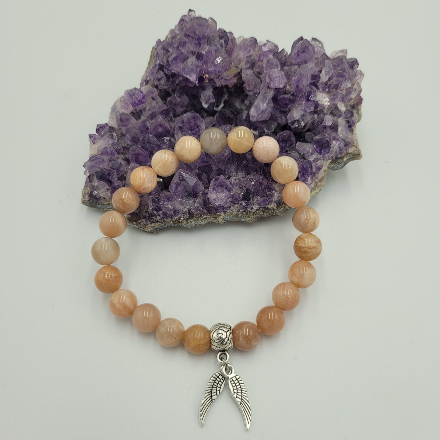 Bracelet Peach Moon stone 8mm Wings